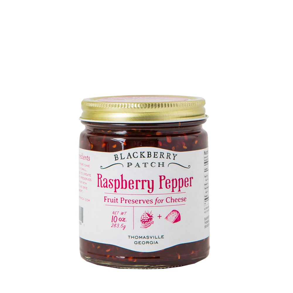 10oz glass jar of Blackberry Patch Raspberry Pepper Fruit Preserves for Cheese with gold screw on lid. 