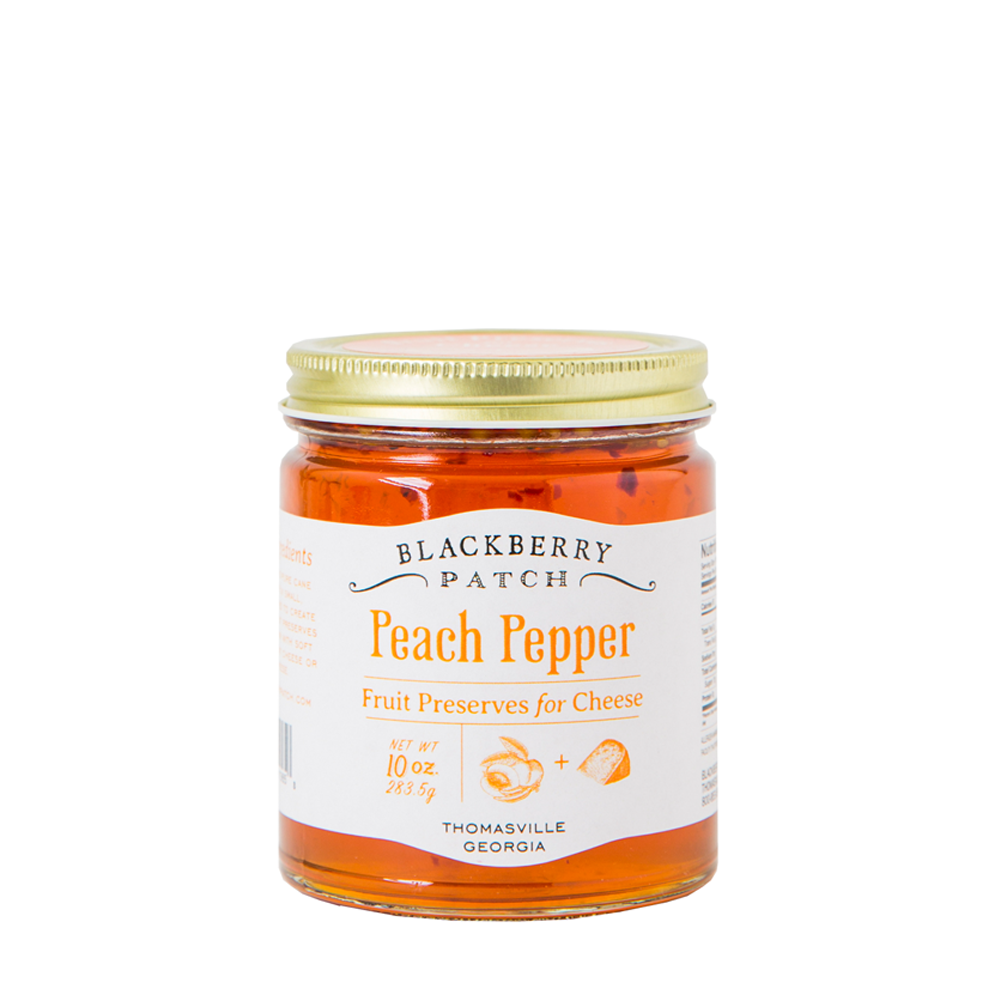 10oz glass jar of Blackberry Patch Peach Pepper Fruit Preserves for Cheese with gold screw on lid. 