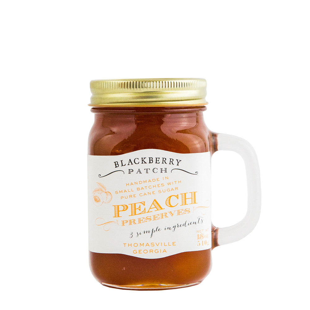 19oz jar of Blackberry Patch Peach Preserves. Jar is a handled mug with gold screw top. 