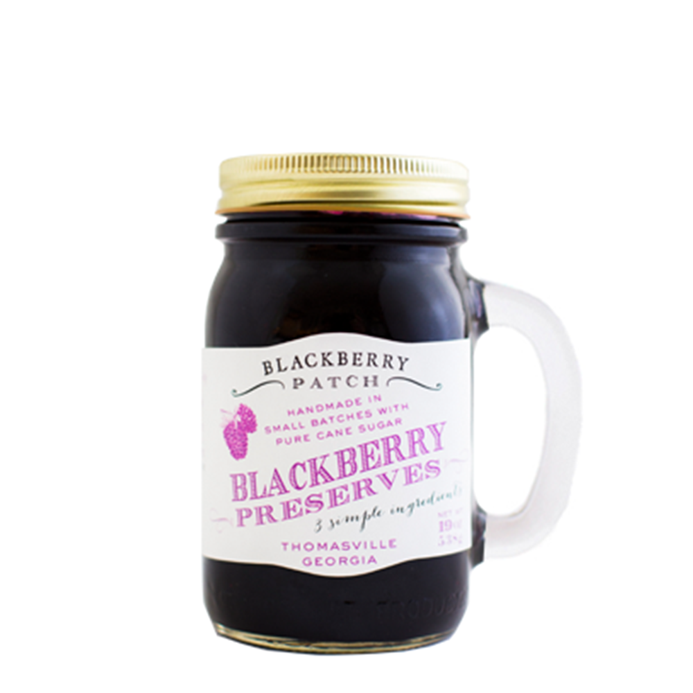 19oz jar of Blackberry Patch Blackberry Preserves. Jar is a handled mug with gold screw top. 