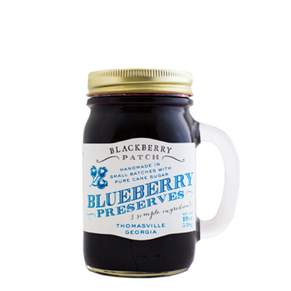 19oz jar of Blackberry Patch Blueberry Preserves. Jar is a handled mug with gold screw top. 