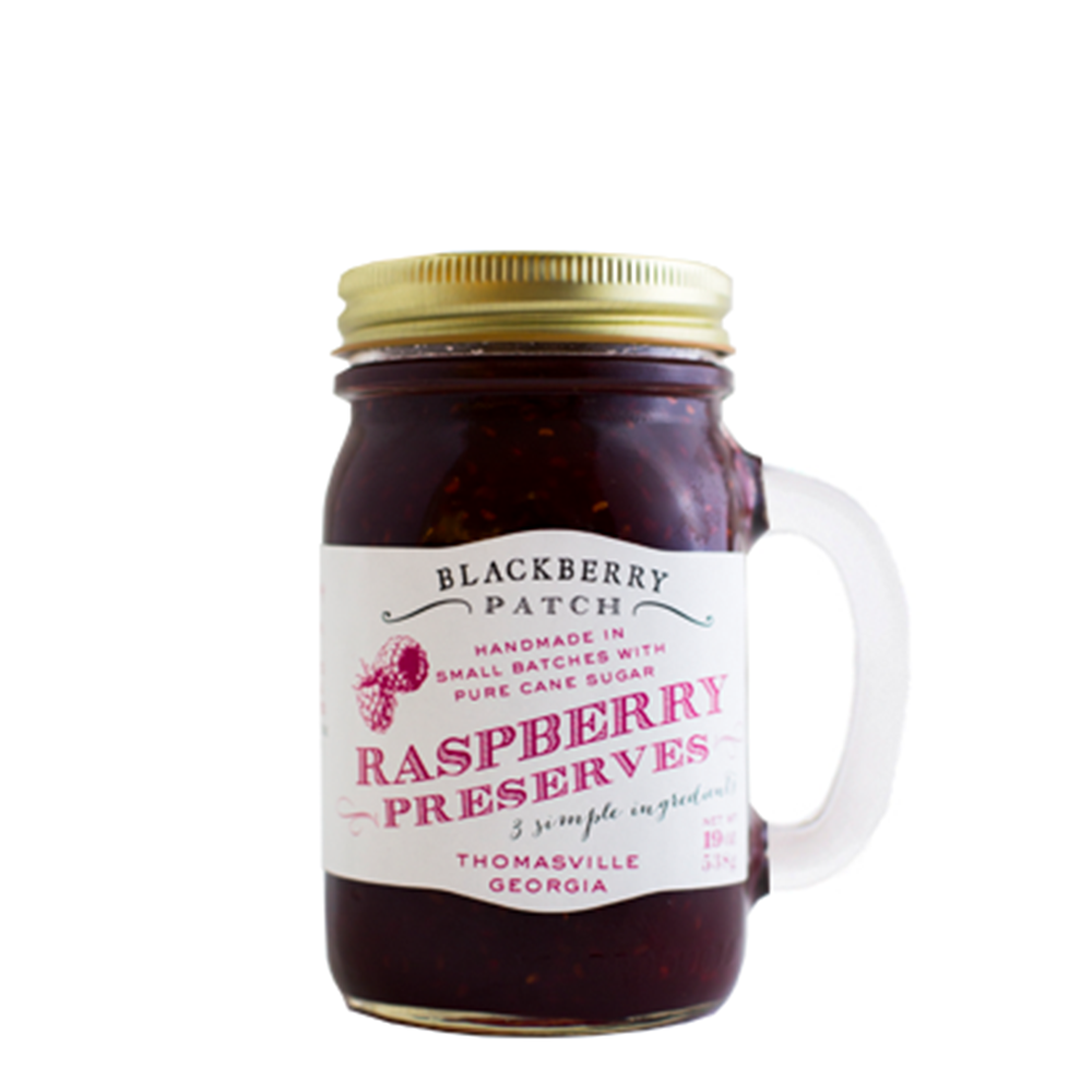19oz jar of Blackberry Patch Raspberry Preserves. Jar is a handled mug with gold screw top. 