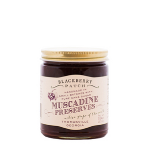 10oz jar of Blackberry Patch Muscadine Preserves with gold screw on lid. 