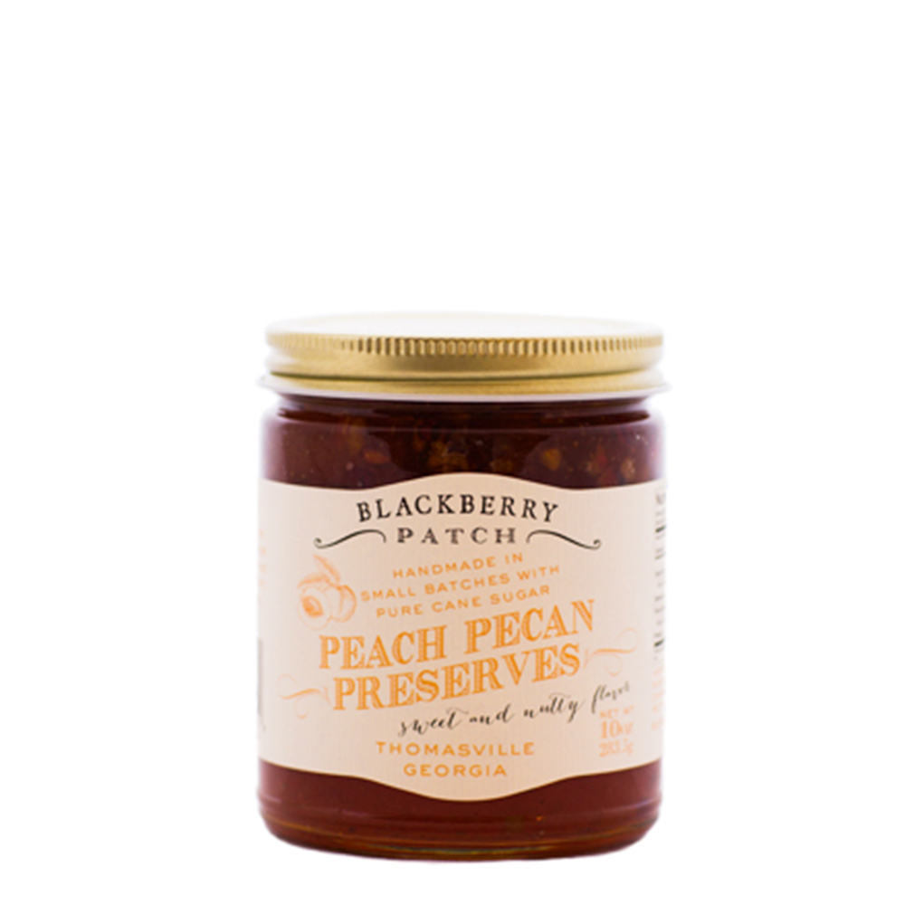 10oz glass jar of Blackberry Patch Peach Pecan Preserves with gold screw on lid. 